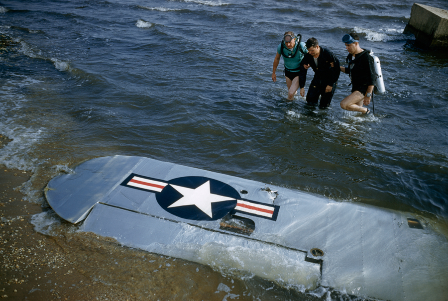 A Civil Air Patrol rescue team aids a pilot whose plane was downed outside of Long Island, May 1956