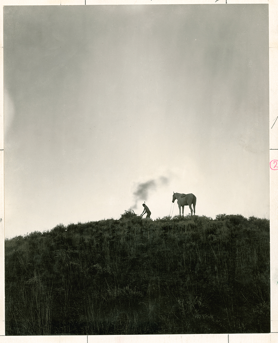 A Native American sends smoke signals in Montana, June 1909