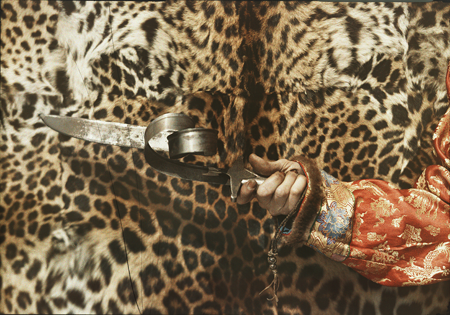 A Tibetan spiritual figure holds a Mongolian blade after twisting it with his seemingly superhuman strength, 1935