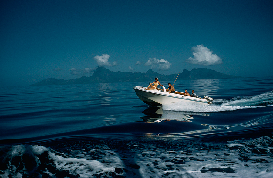 A motorboat carries tourists to fishing grounds off Tahiti, July 1962