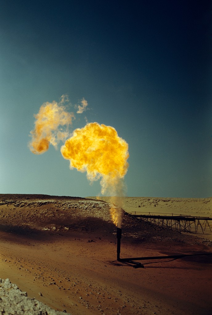 A pipe emits poisonous gases in a flame produced by oil production, April 1948