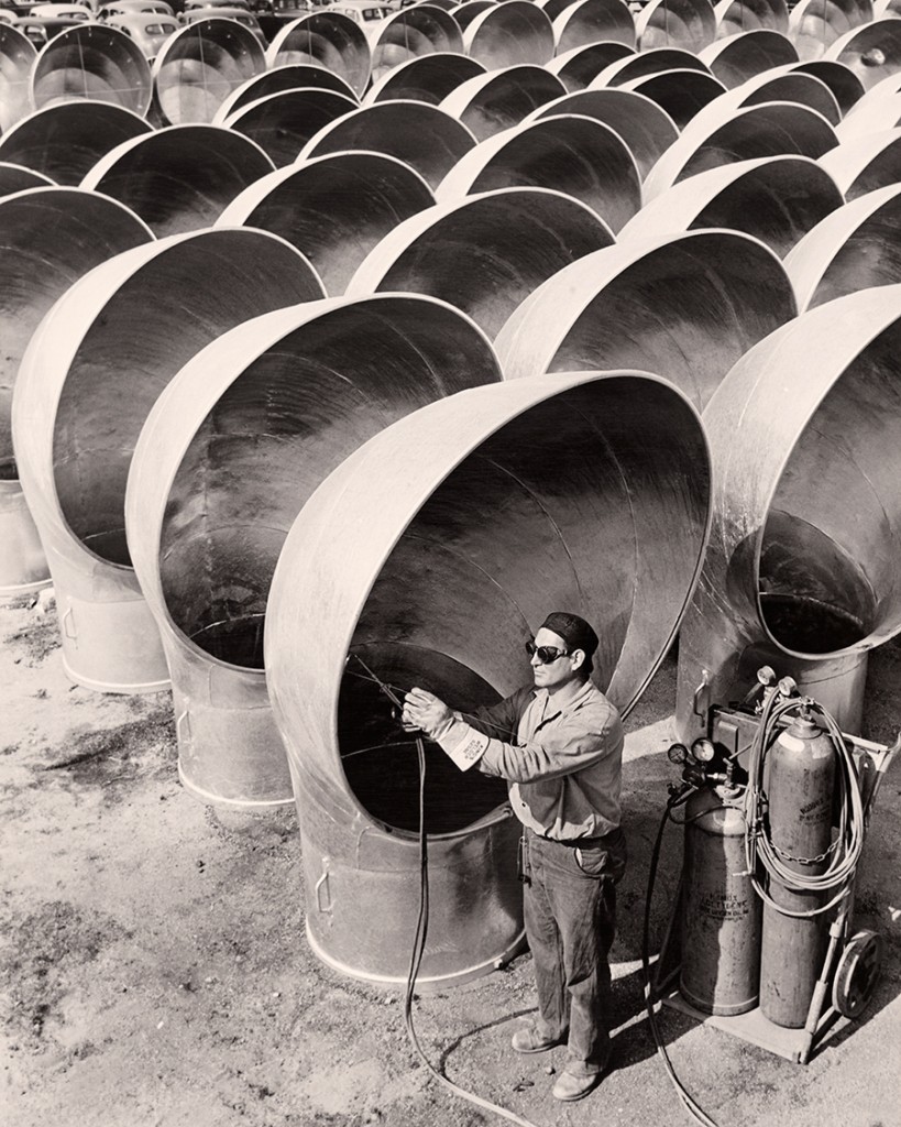 A welder works on cowls for liberty ships in California, 1942