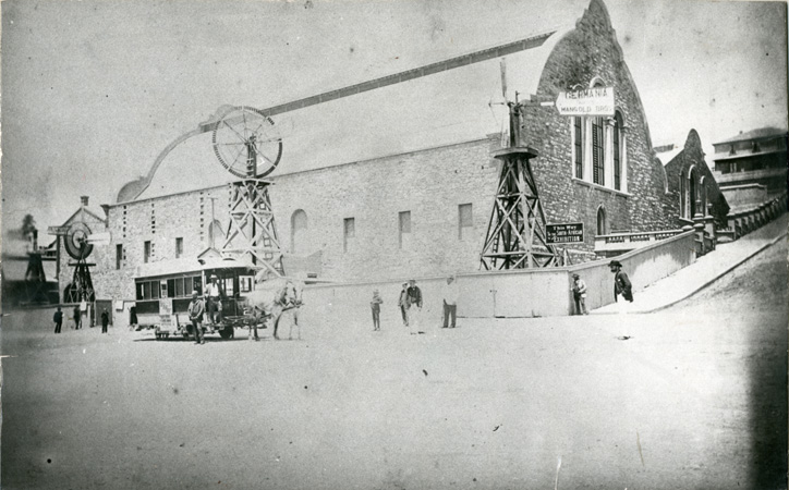 A horse tram is drawn up outside the hall